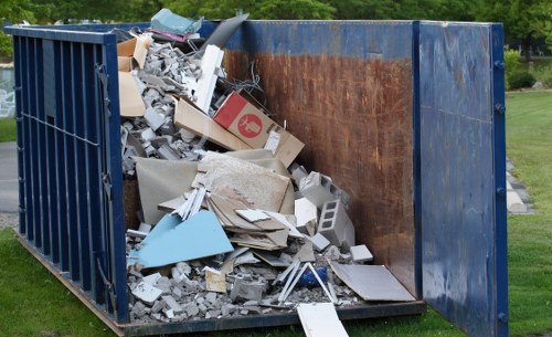 Construction site with builders waste being cleared in Watford